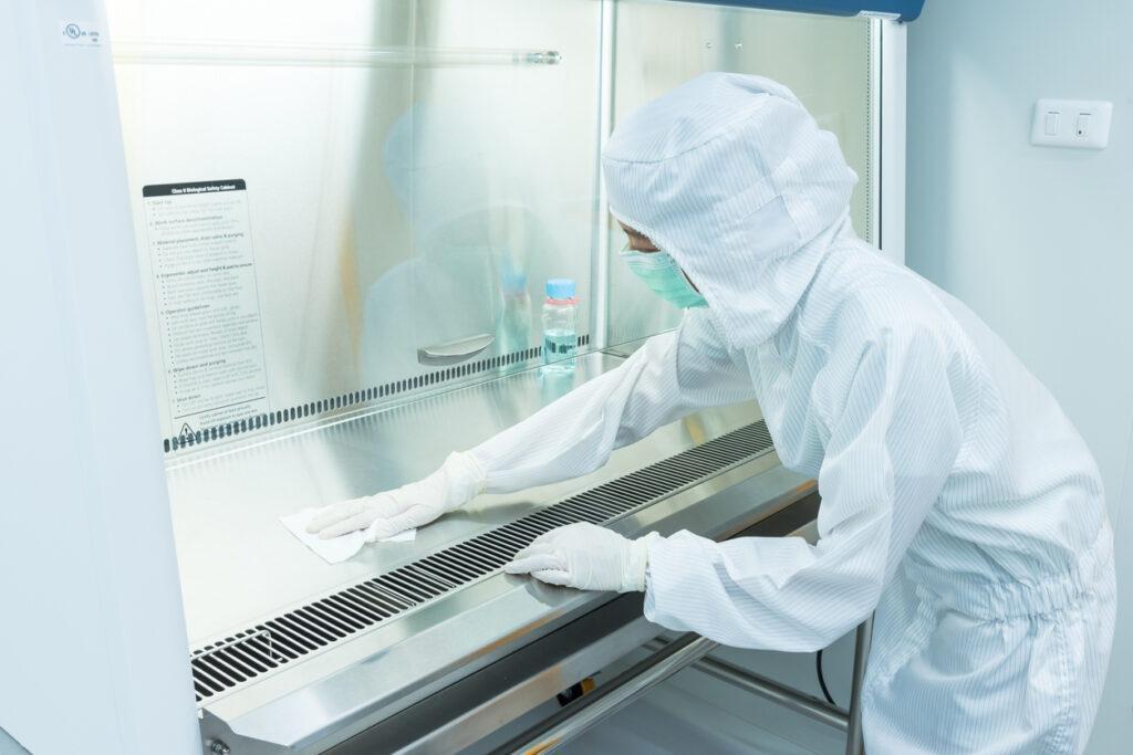 cleanroom worker sanitizing workspace