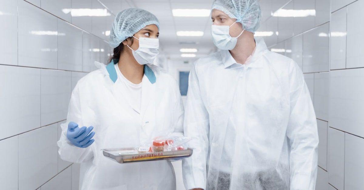 scientists having a discussion in biotech cleanroom