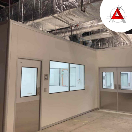 Modular wall panels being installed in a medical manufacturing facility