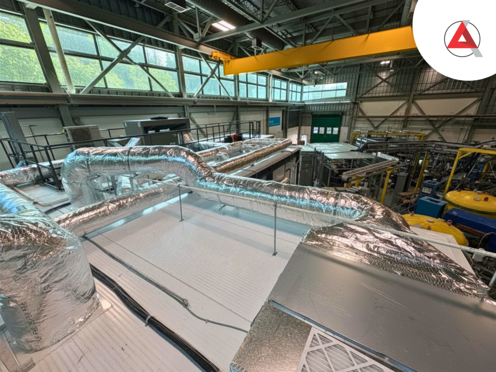 Industrial overhead structural framework and complex utility ducting integrated by ACH Solutions to support heavy-duty liquid-cooling manifolds.