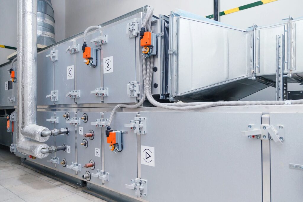 Cleanroom air handling unit with damper actuators and chilled water piping representing the HVAC equipment that controls humidity and moisture during storm season