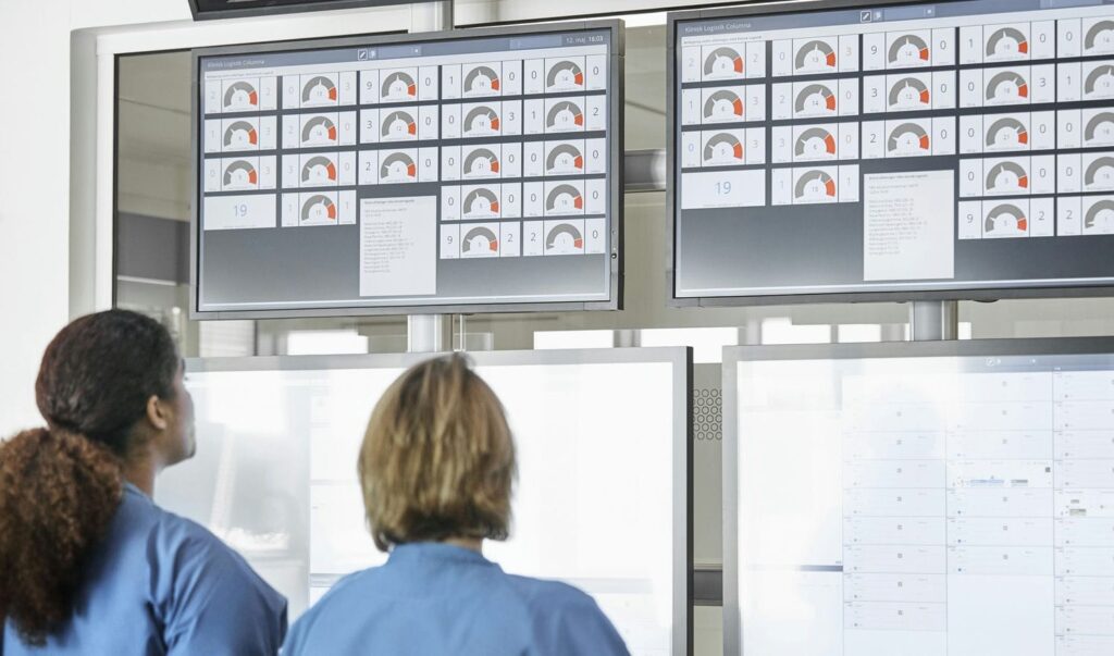 Facility team monitoring control room dashboards during a storm-related event affecting cleanroom HVAC