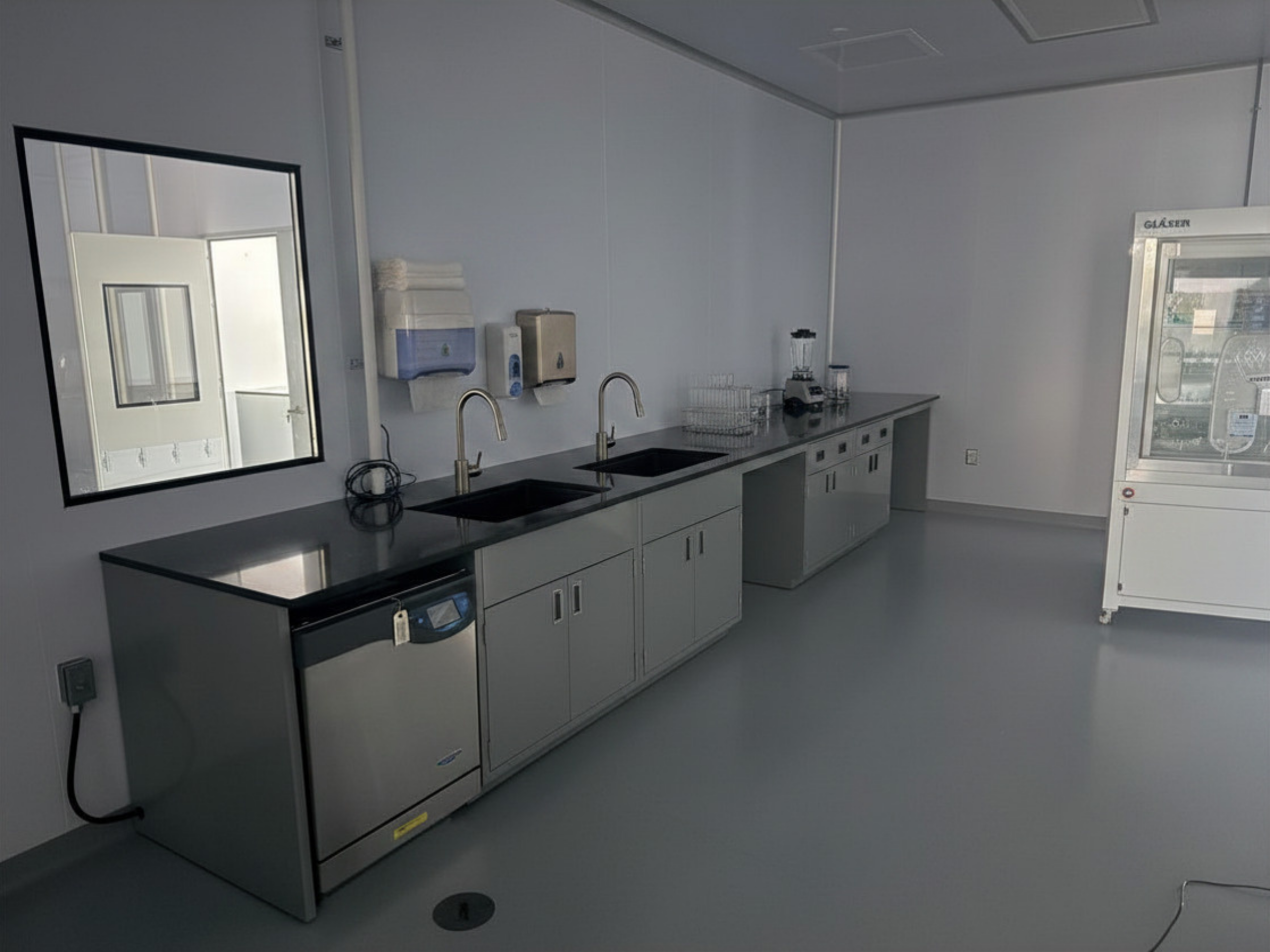 Completed dry room interior with perimeter workbenches and sealed modular panel walls