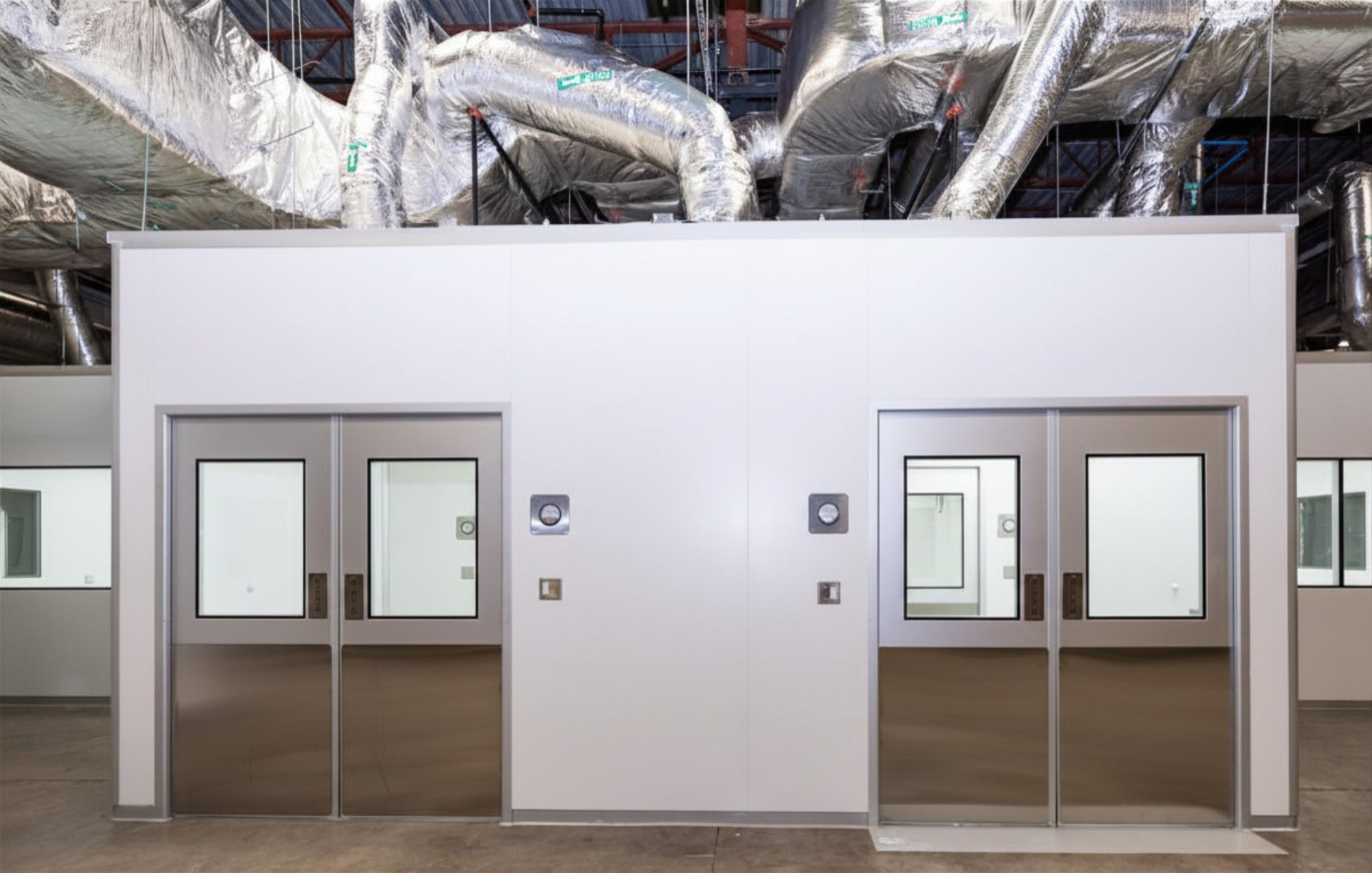 Monitored cleanroom airlock doors in a validated controlled environment