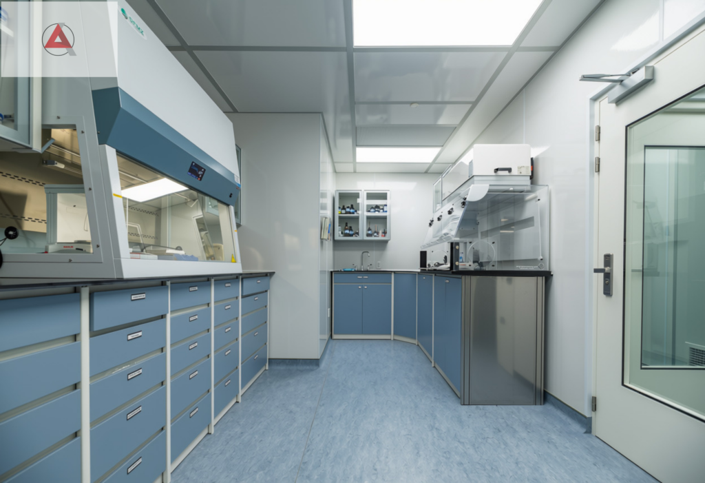 Completed, sterile-ready pharmacy compounding suite featuring custom laboratory casework and integrated modular panel framing.