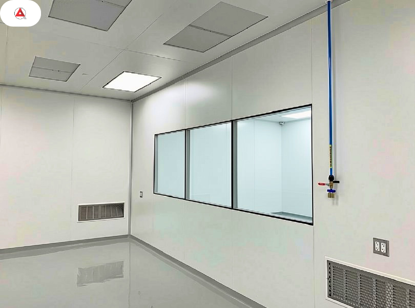 Interior view of an ISO 7 hardwall cleanroom suite showing seamless wall coving and low-level return air grilles