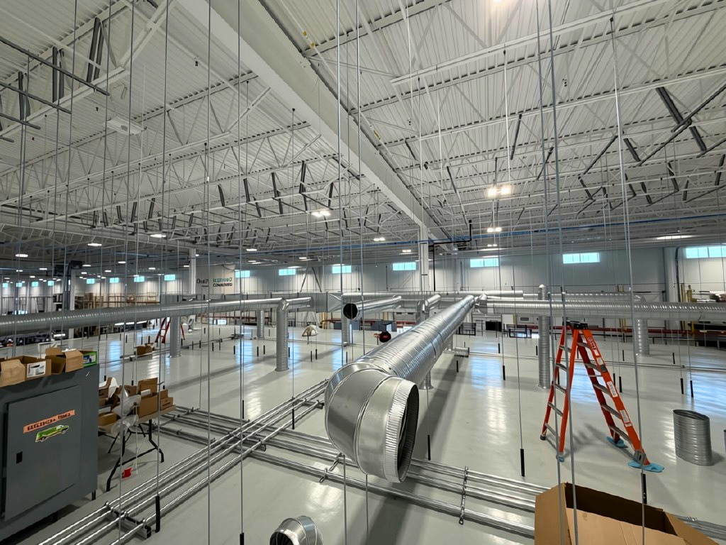 Cleanroom construction underway beneath the existing warehouse structure in Calgary, Alberta, built in phases around live production