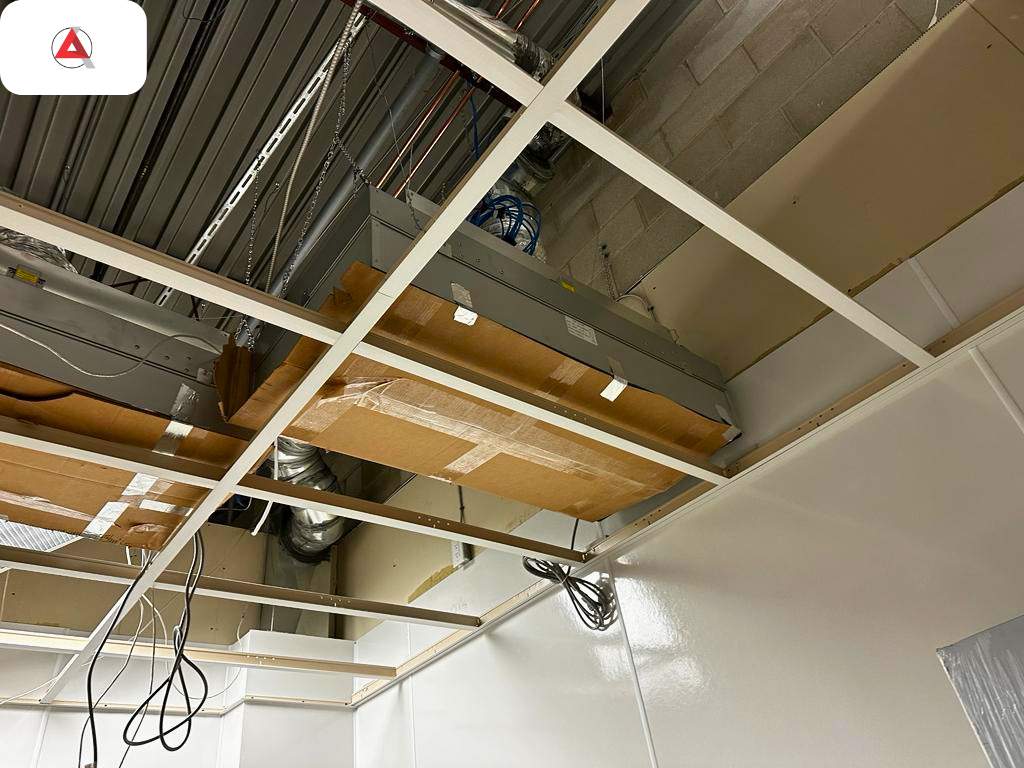 Overhead HVAC ductwork and low-profile ceiling plenum engineering for a NAPRA pharmacy cleanroom retrofit
