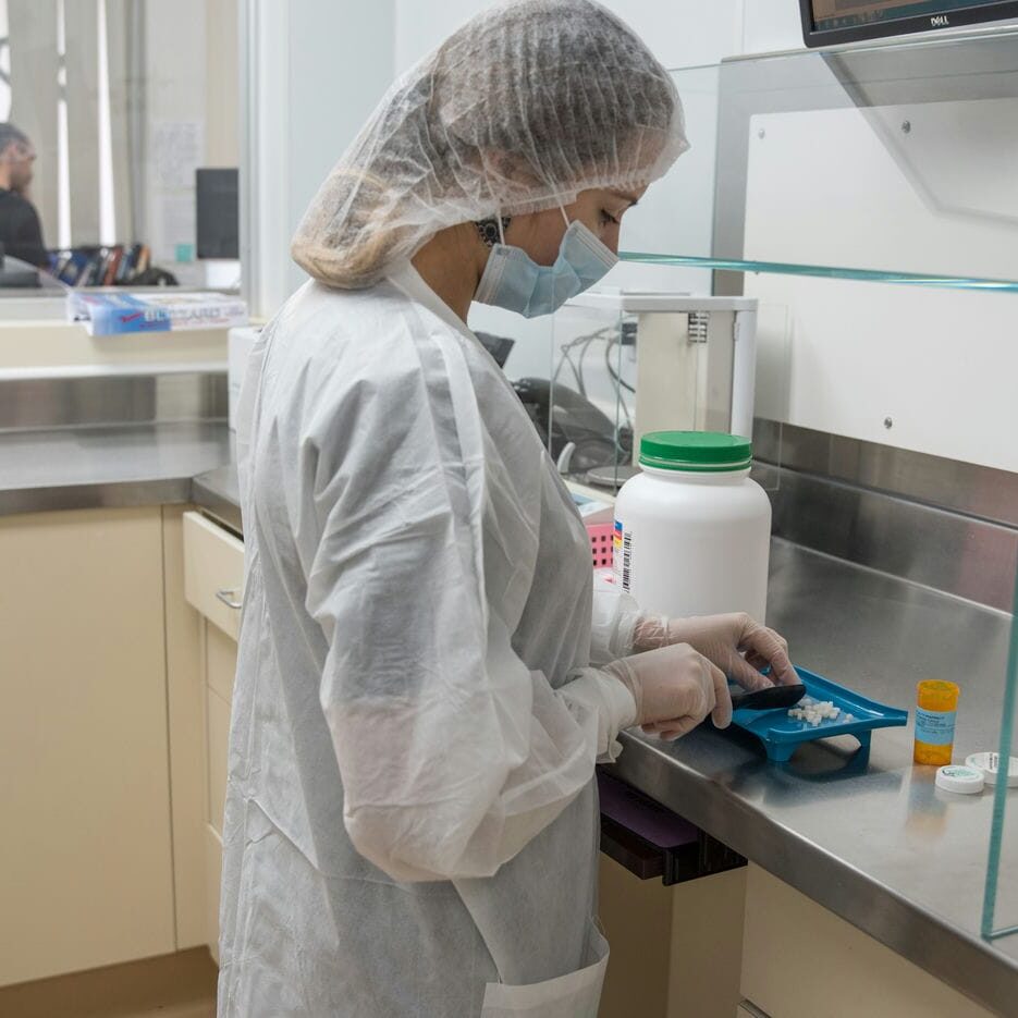 woman working in compounding pharmacy